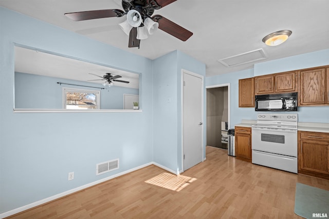 kitchen with white electric stove and light hardwood / wood-style flooring