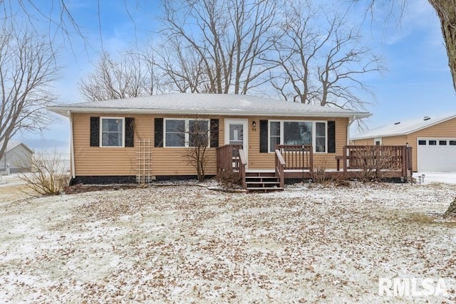 view of front of house with a wooden deck and a garage