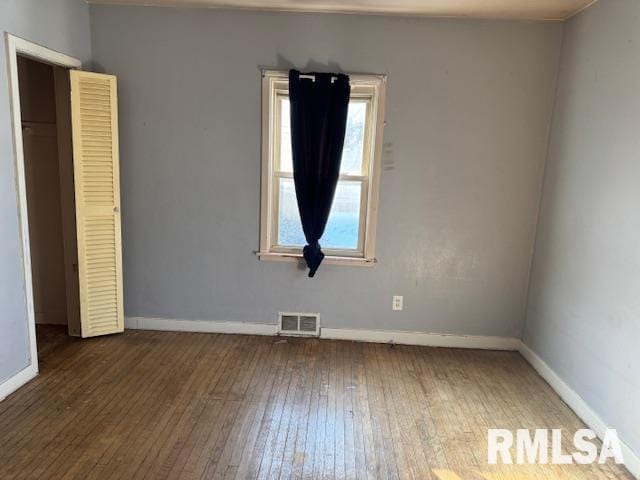 empty room with dark hardwood / wood-style floors