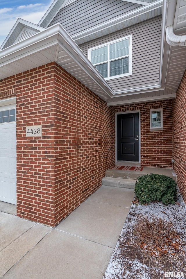 view of exterior entry featuring a garage