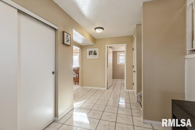 hallway with light tile patterned flooring