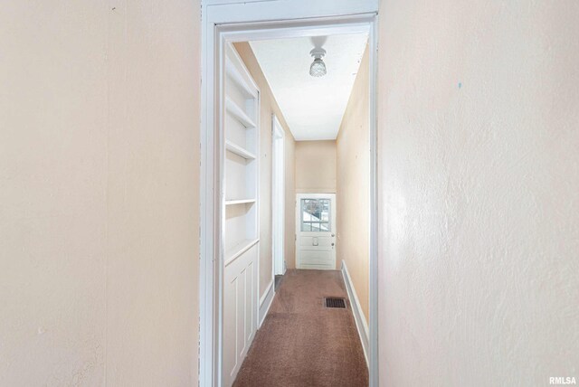 unfurnished room with french doors, light colored carpet, ornamental molding, and built in shelves