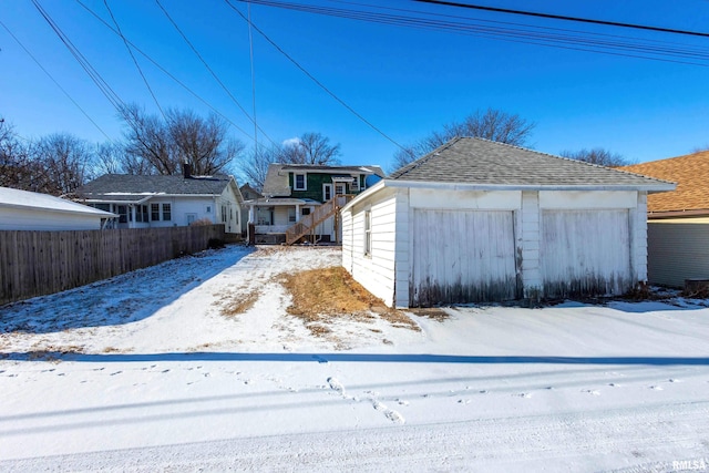 snowy yard featuring an outbuilding