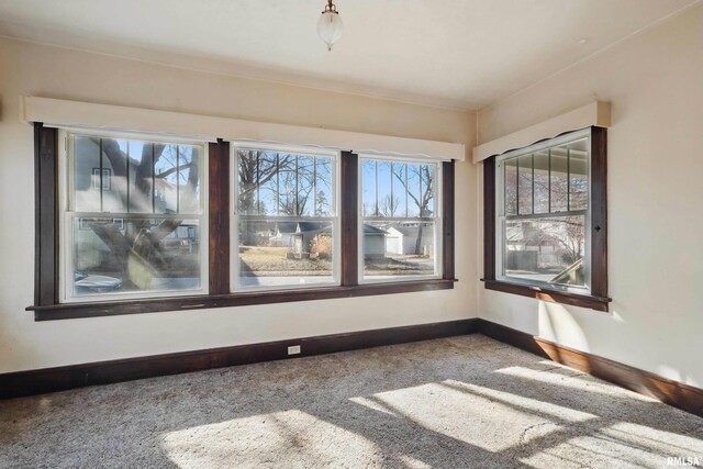 unfurnished living room with ceiling fan, carpet flooring, and a fireplace