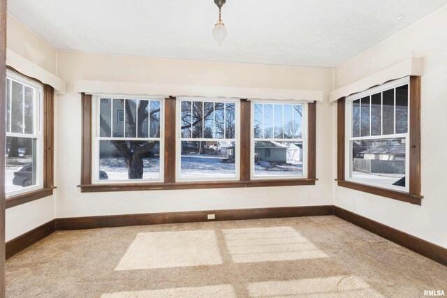 unfurnished living room with ceiling fan, a brick fireplace, built in features, and ornate columns