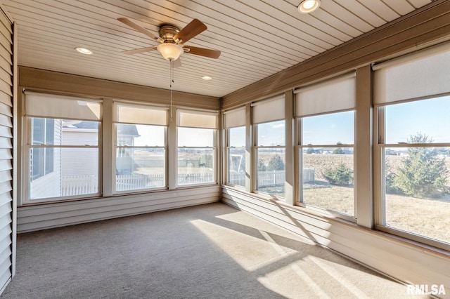 unfurnished sunroom with ceiling fan and wood ceiling