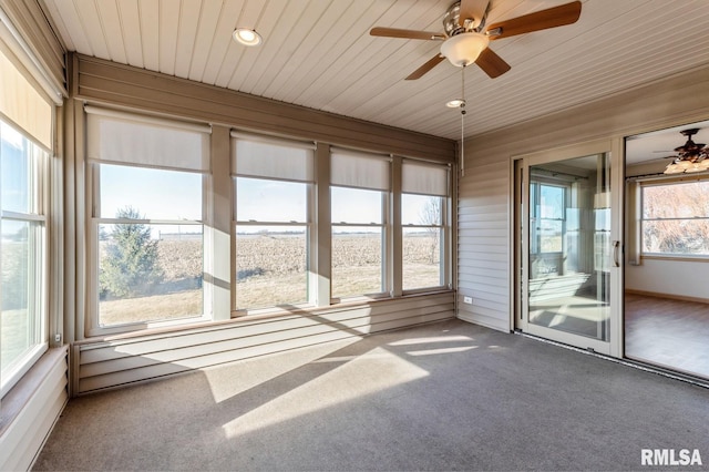 unfurnished sunroom featuring ceiling fan