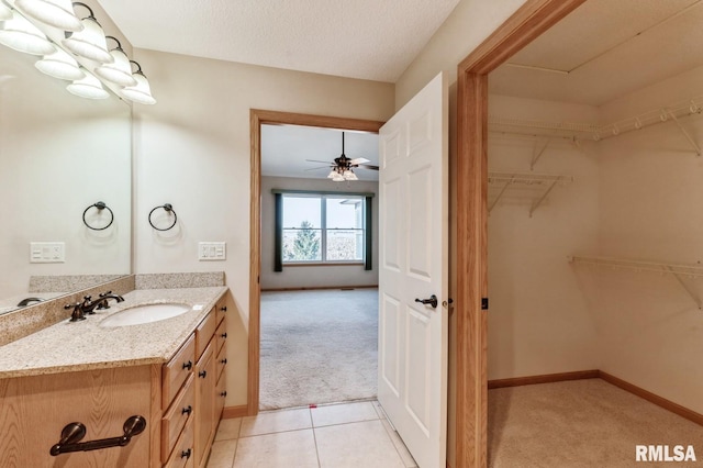 bathroom featuring vanity, tile patterned flooring, and ceiling fan