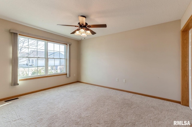 unfurnished room featuring carpet flooring, a textured ceiling, and ceiling fan