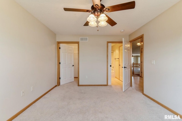 unfurnished bedroom with light carpet, connected bathroom, and ceiling fan