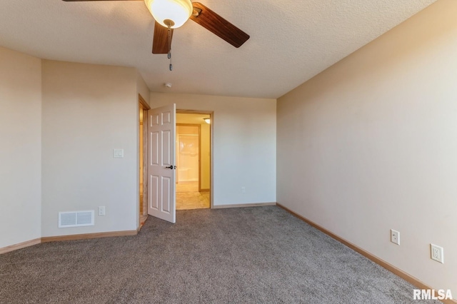 unfurnished bedroom featuring ceiling fan, carpet floors, and a textured ceiling