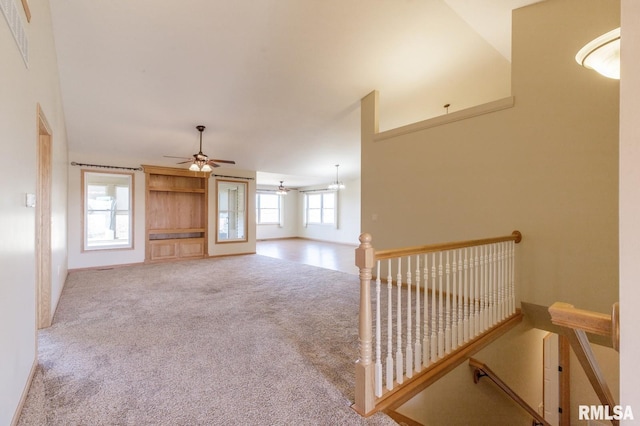 unfurnished living room with carpet floors and ceiling fan