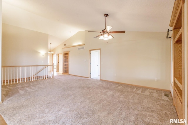 spare room with lofted ceiling, light colored carpet, and ceiling fan