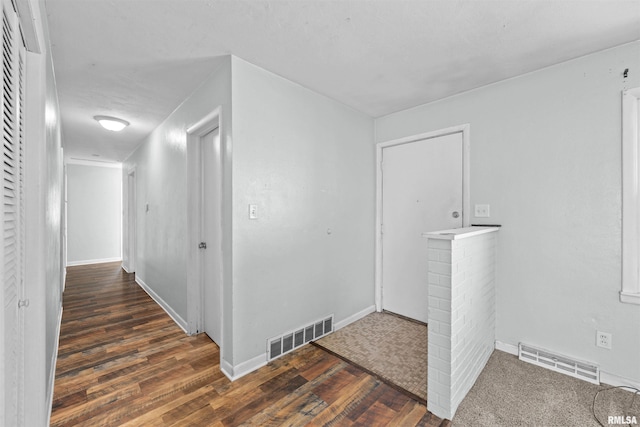 hallway with dark hardwood / wood-style floors