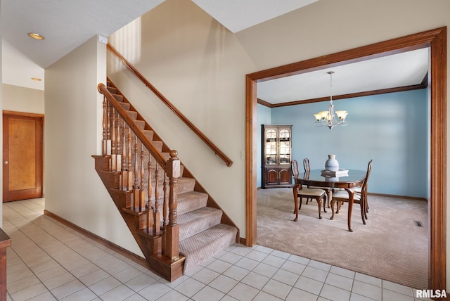 stairs with tile patterned flooring, crown molding, and a chandelier