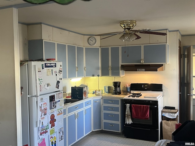 kitchen featuring ceiling fan, range with gas stovetop, and white fridge