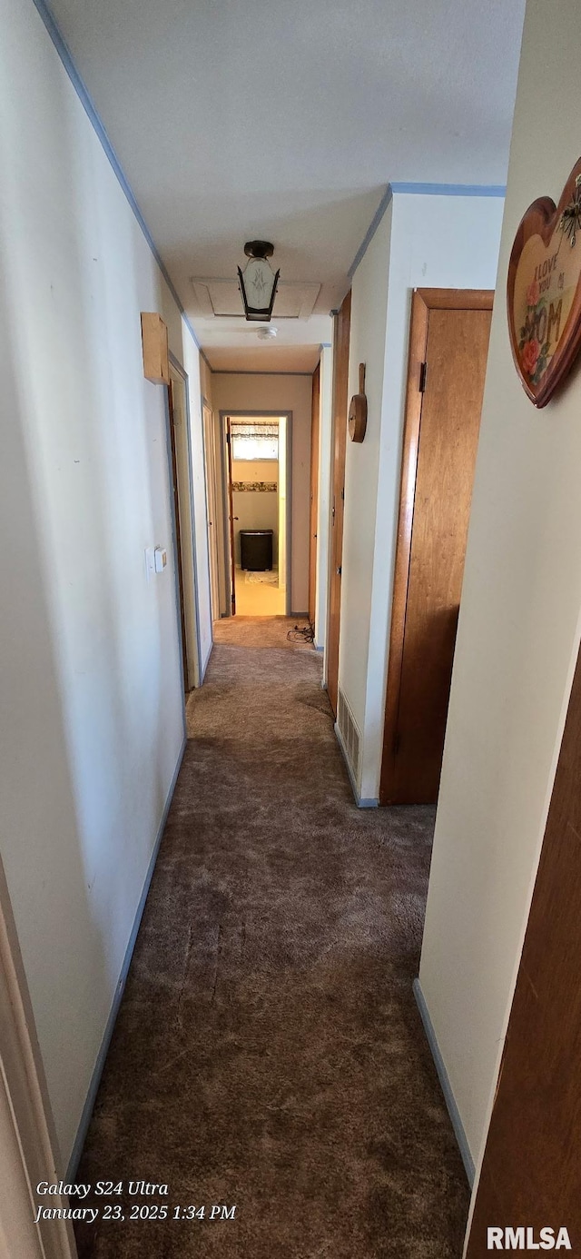 hall featuring dark colored carpet