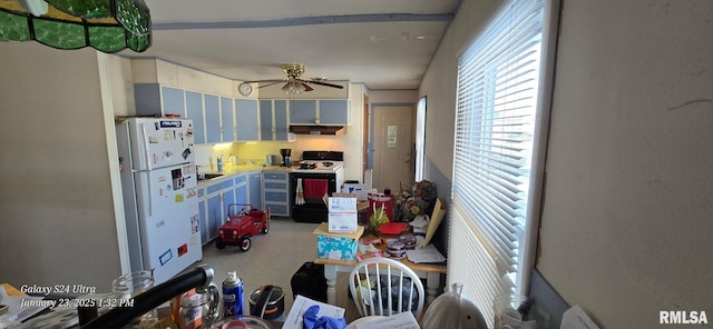 kitchen with ceiling fan, white appliances, and blue cabinets