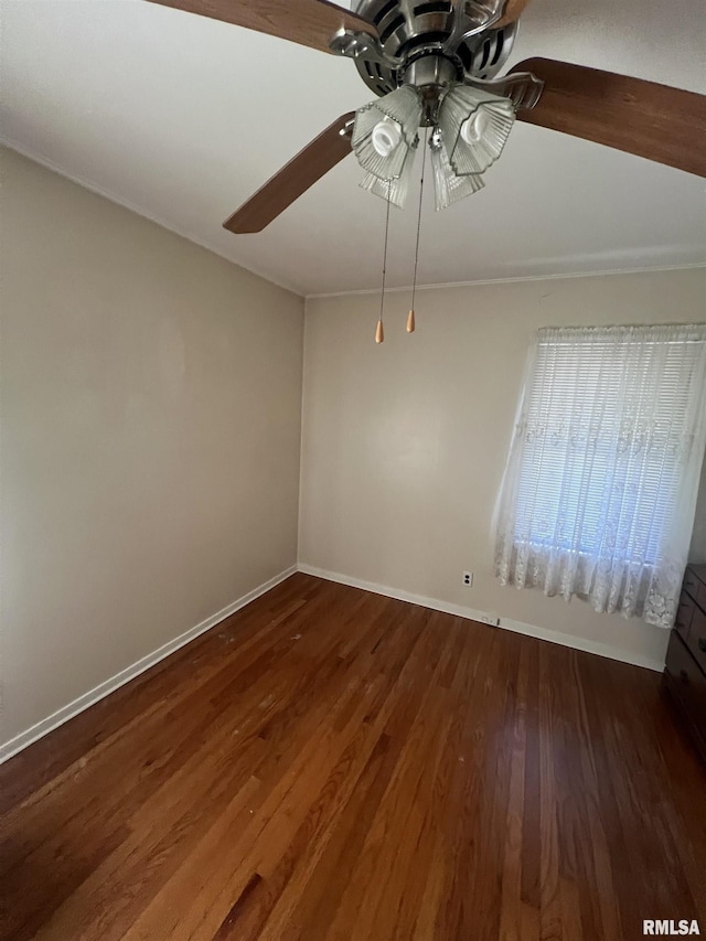 spare room with ceiling fan and dark hardwood / wood-style flooring