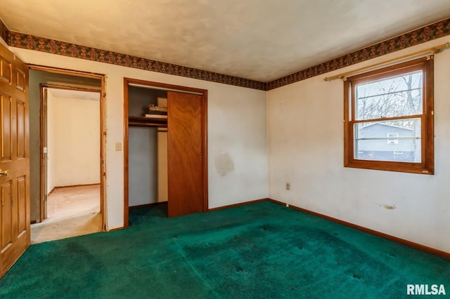 unfurnished bedroom with dark carpet and a closet