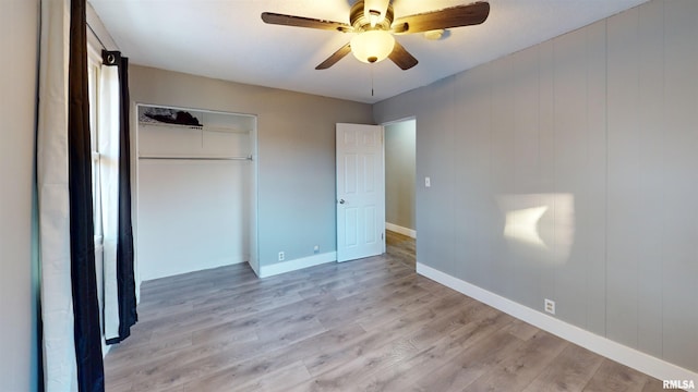 unfurnished bedroom with ceiling fan, a closet, and light hardwood / wood-style flooring