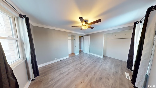 unfurnished bedroom with crown molding, light hardwood / wood-style flooring, and ceiling fan