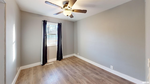 spare room featuring light hardwood / wood-style flooring and ceiling fan