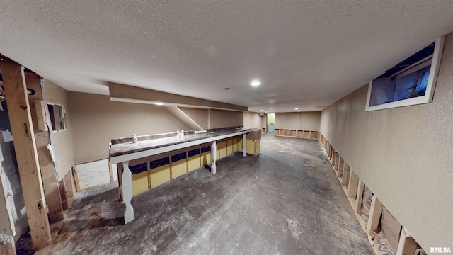 basement featuring a textured ceiling