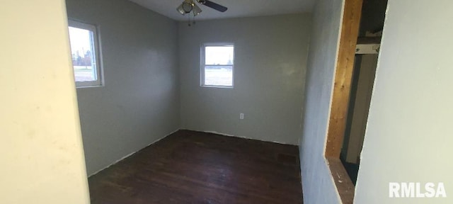 spare room featuring dark wood-type flooring and ceiling fan