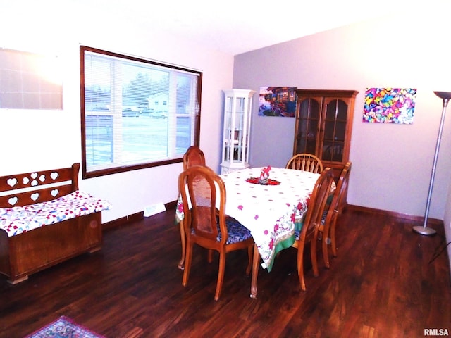 dining space with dark wood-type flooring