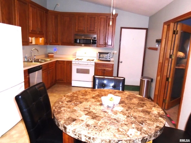 kitchen featuring sink, vaulted ceiling, and stainless steel appliances