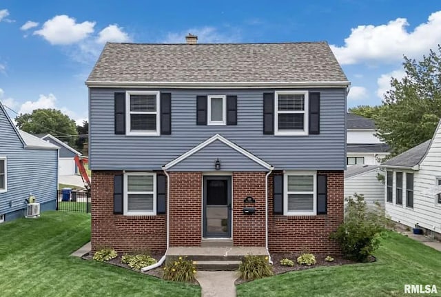 view of front of home with central AC unit and a front lawn