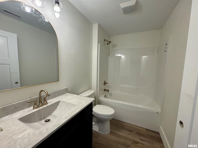 full bathroom featuring vanity, toilet, bathing tub / shower combination, and hardwood / wood-style floors