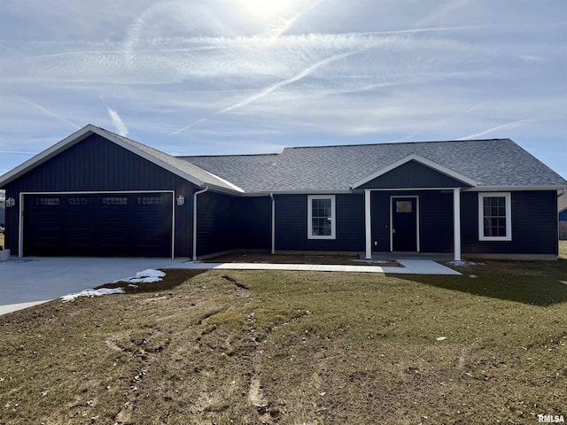 ranch-style home featuring a garage and a front lawn