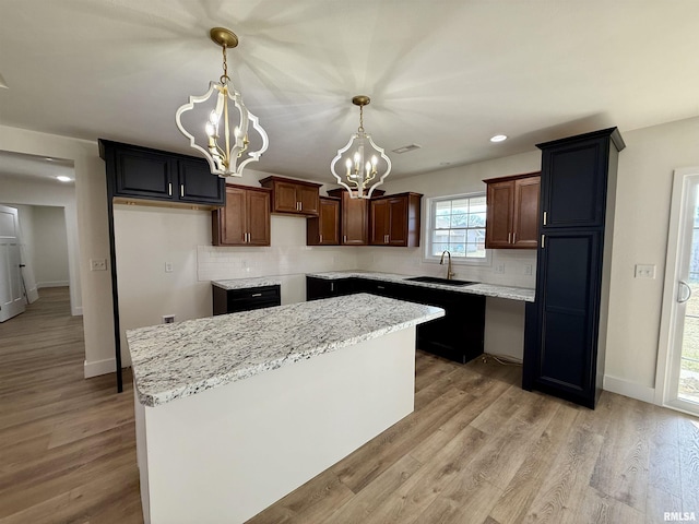 kitchen featuring a chandelier, a center island, and tasteful backsplash