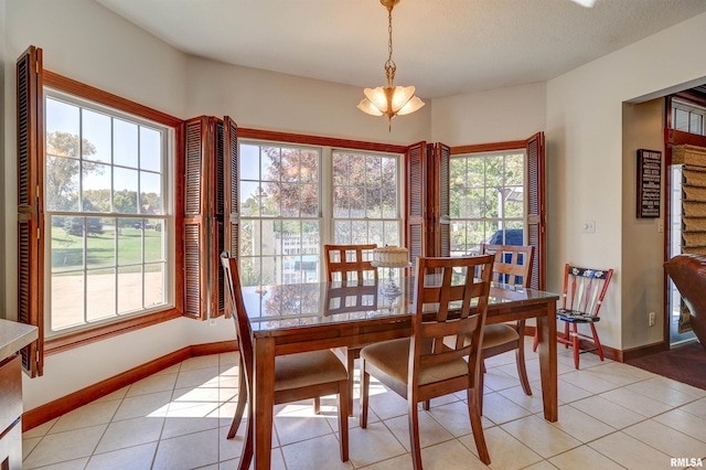 dining space featuring light tile patterned floors and plenty of natural light