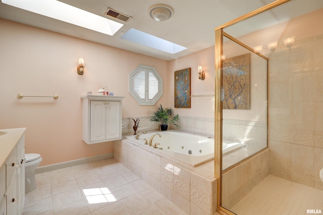 full bathroom with tile patterned flooring, a skylight, vanity, shower with separate bathtub, and toilet