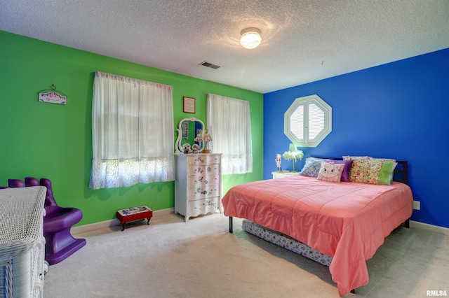 bedroom featuring carpet and a textured ceiling