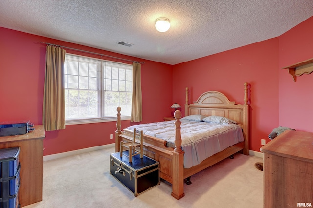 carpeted bedroom featuring a textured ceiling