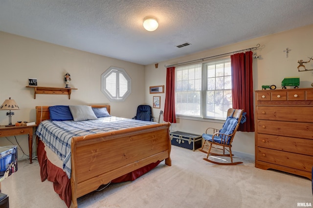 carpeted bedroom featuring a textured ceiling