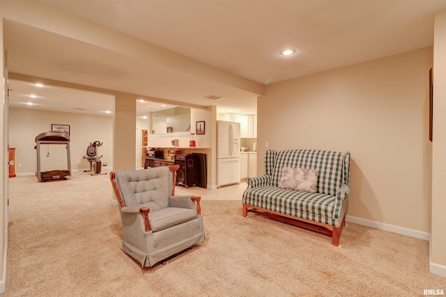 living room featuring light colored carpet and indoor bar