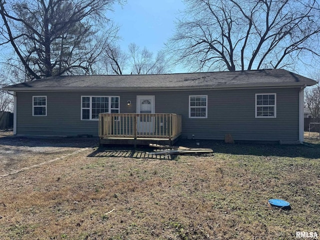 rear view of house featuring a wooden deck