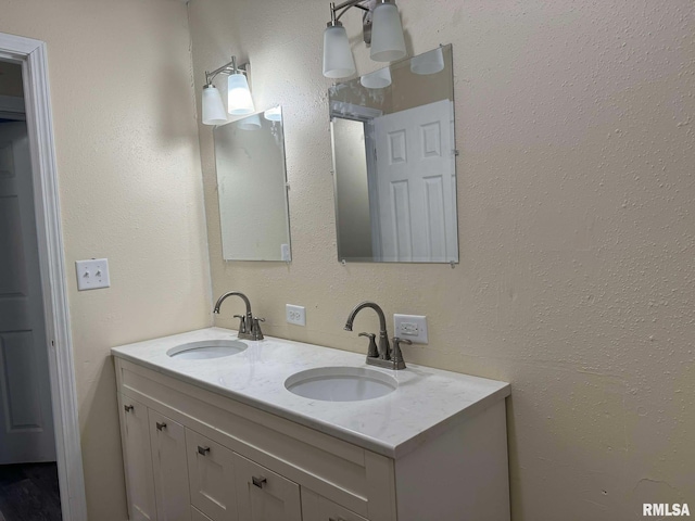 bathroom featuring a sink and double vanity