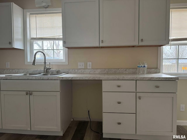 kitchen featuring sink and white cabinets