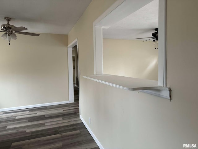 hall featuring baseboards and wood finished floors