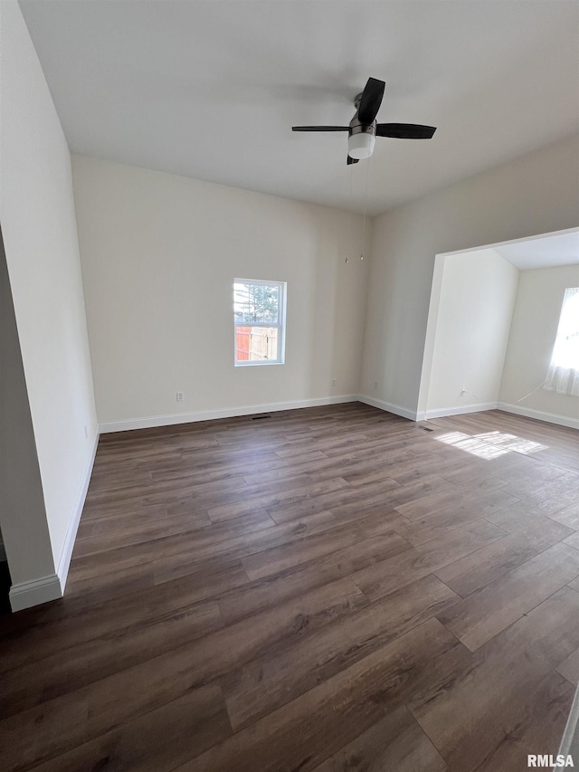 unfurnished room featuring ceiling fan and dark hardwood / wood-style flooring