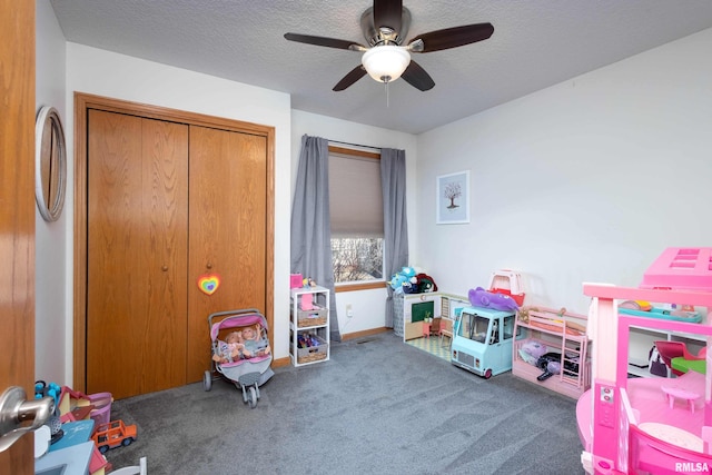 rec room with a textured ceiling and dark carpet