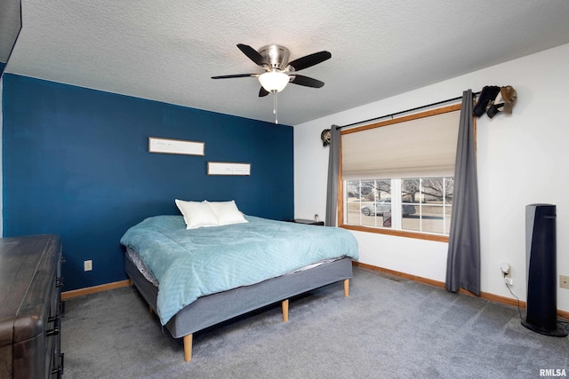 bedroom with a textured ceiling, ceiling fan, and carpet