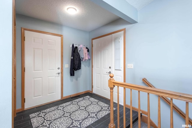 foyer entrance featuring a textured ceiling