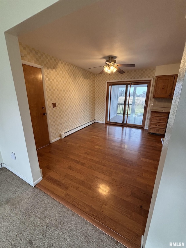 empty room featuring ceiling fan, a baseboard radiator, and dark hardwood / wood-style floors